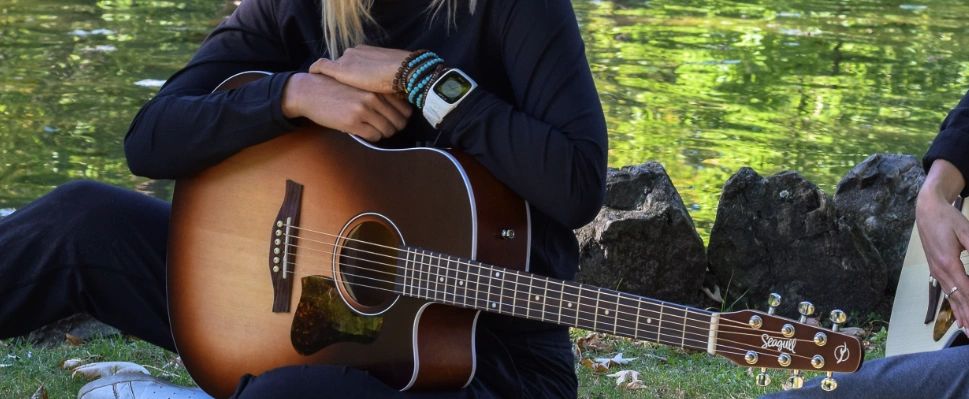 Image of someone holding a Seagull Guitar on their lap to convey the Best Acoustic Guitar Brand
